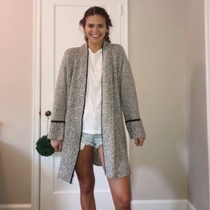 White, gray and black stitched cardigan.